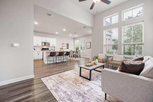 7902 Sutcliffe Dr, Austin, TX 78744 - living room with a ceiling fan, baseboards, wood finished floors, and recessed lighting