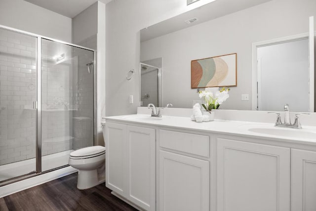 7902 Sutcliffe Dr, Austin, TX 78744 - full bath with toilet, double vanity, a shower stall, and wood finished floors
