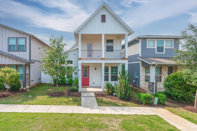7902 Sutcliffe Dr, Austin, TX 78744 - view of front facade with a balcony, board and batten siding, stone siding, and a front lawn