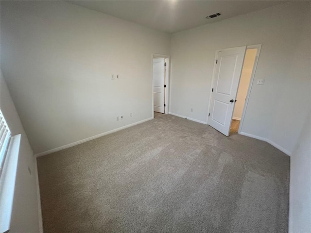 unfurnished bedroom featuring visible vents, baseboards, and carpet flooring