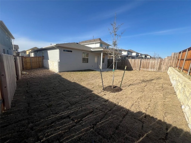 back of house featuring a fenced backyard