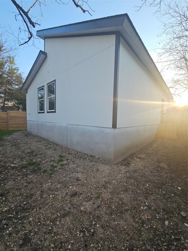 view of home's exterior with fence