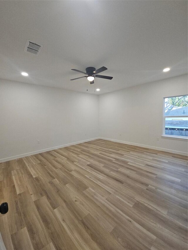 spare room featuring baseboards, visible vents, recessed lighting, ceiling fan, and light wood-type flooring