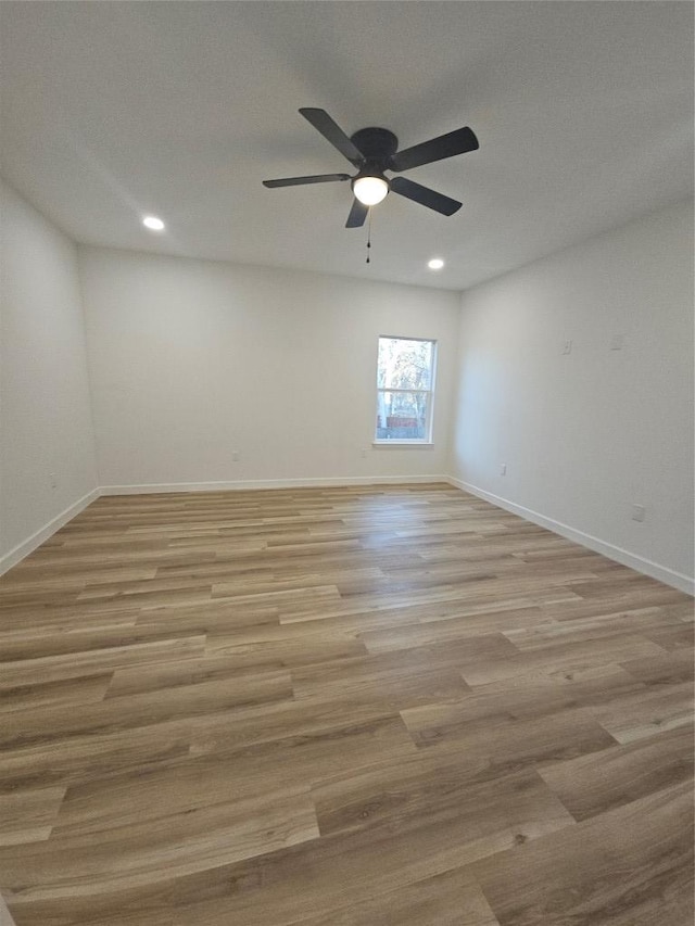 empty room featuring ceiling fan, baseboards, light wood-style flooring, and recessed lighting