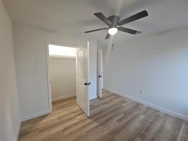 empty room with visible vents, baseboards, and light wood-style floors