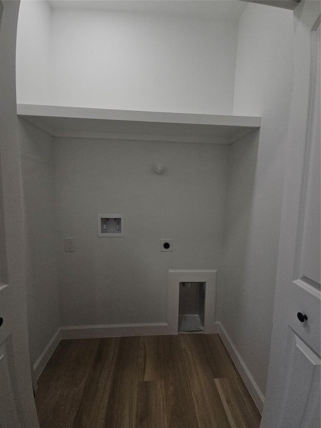 clothes washing area featuring electric dryer hookup, wood finished floors, baseboards, hookup for a washing machine, and laundry area