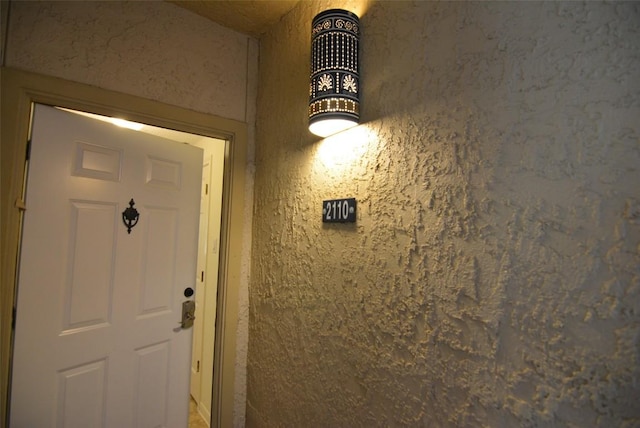 doorway to property featuring stucco siding