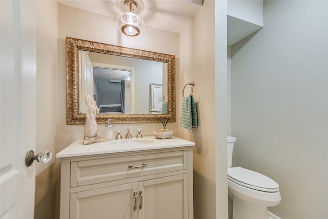 bathroom featuring toilet and vanity