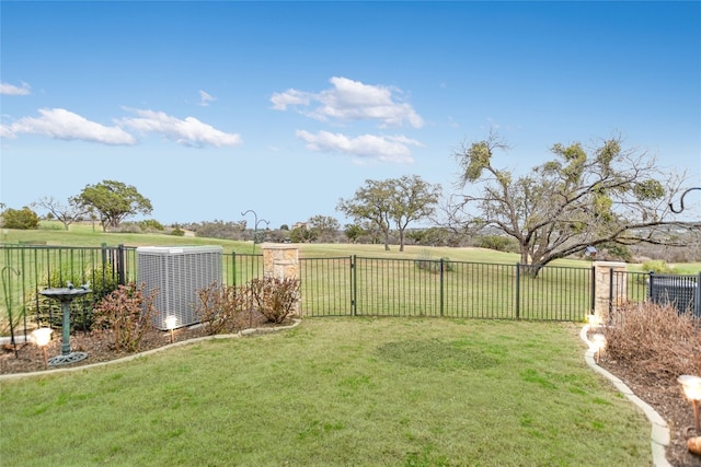 view of yard with central air condition unit and fence