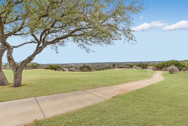 view of property's community with a lawn