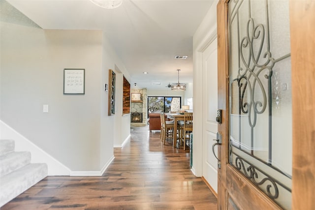 foyer entrance with visible vents, dark wood finished floors, recessed lighting, baseboards, and stairs