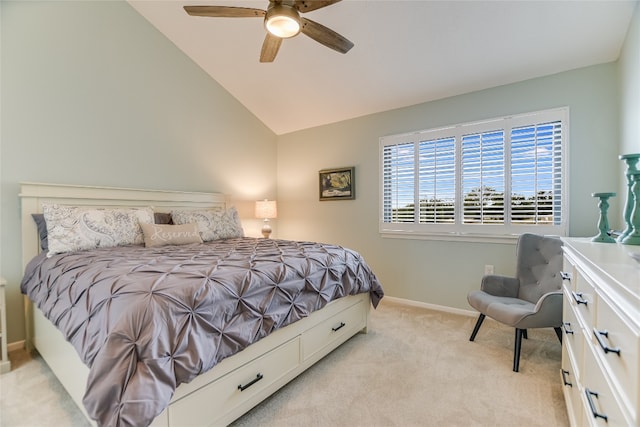 bedroom with light colored carpet, baseboards, lofted ceiling, and ceiling fan