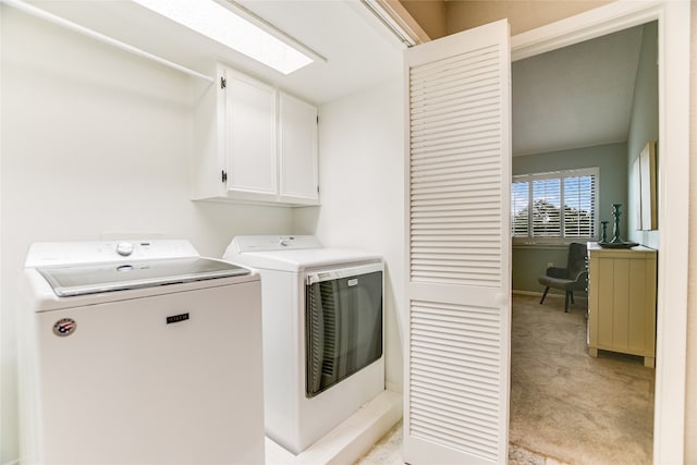 laundry room with washing machine and clothes dryer, cabinet space, and light colored carpet