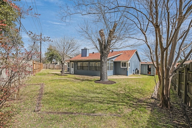 13202 Elysian Fields Cv, Austin, TX 78727 - back of property featuring a fenced backyard, a chimney, and a shingled roof