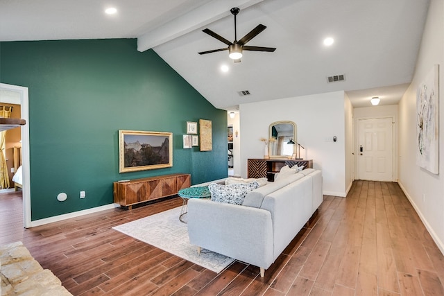 living room featuring wood finished floors, baseboards, visible vents, lofted ceiling with beams, and ceiling fan