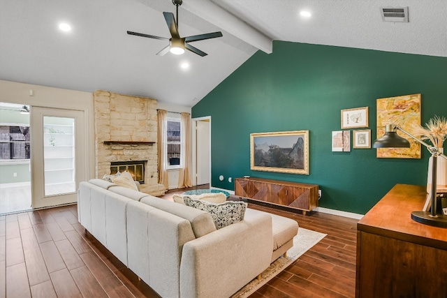 13202 Elysian Fields Cv, Austin, TX 78727 - living area featuring a ceiling fan, dark wood-style flooring, beam ceiling, a stone fireplace, and high vaulted ceiling