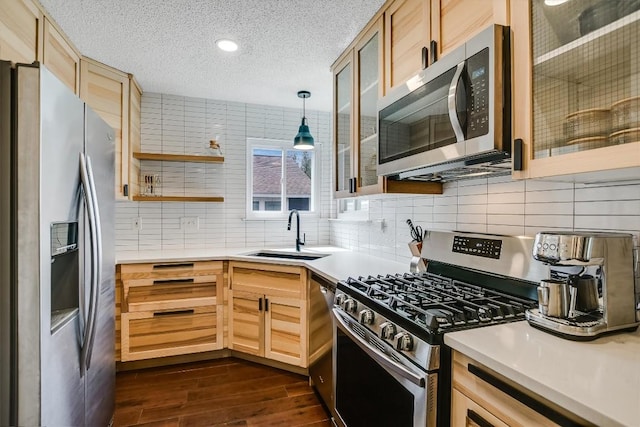 13202 Elysian Fields Cv, Austin, TX 78727 - kitchen with appliances with stainless steel finishes, light brown cabinets, dark wood-style flooring, tasteful backsplash, and a textured ceiling