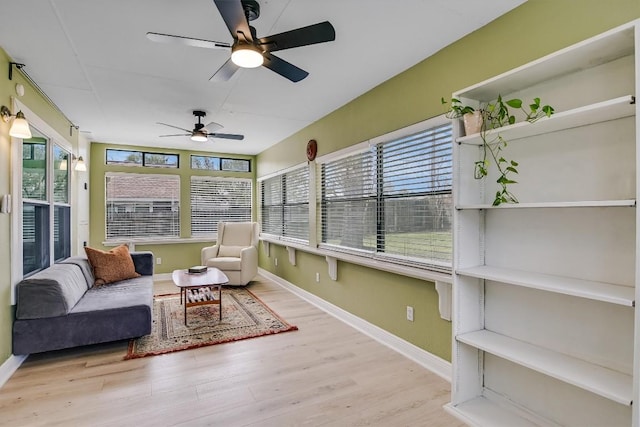 sunroom / solarium featuring ceiling fan