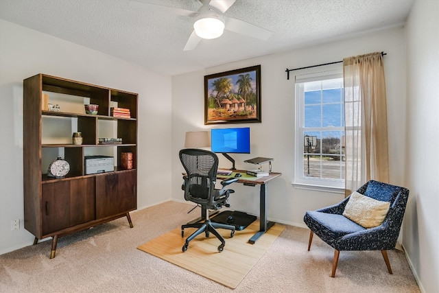 office area with baseboards, a textured ceiling, carpet, and a ceiling fan