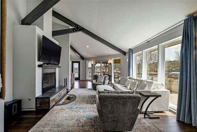 living room with beamed ceiling, high vaulted ceiling, a fireplace with raised hearth, and dark wood finished floors