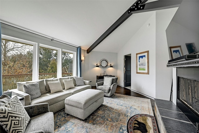 living room with beamed ceiling, wood finished floors, high vaulted ceiling, and a fireplace with raised hearth