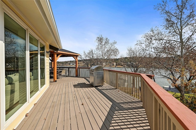 wooden terrace featuring a gazebo and area for grilling