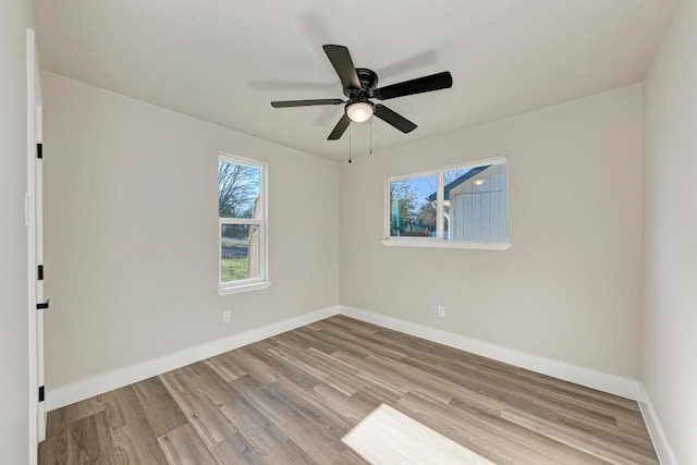 unfurnished room with ceiling fan, baseboards, and wood finished floors