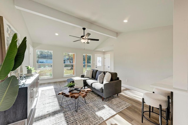 living area featuring lofted ceiling with beams, baseboards, wood finished floors, and recessed lighting