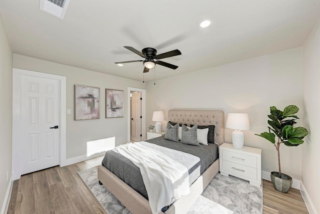 bedroom with light wood-style flooring, recessed lighting, baseboards, and visible vents