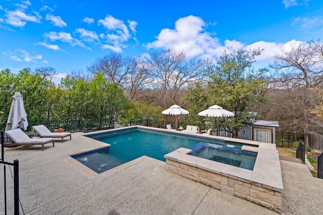 view of pool featuring a patio, a pool with connected hot tub, and fence