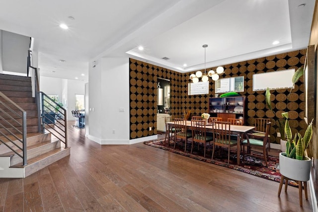 1006 Meriden Ln, Austin, TX 78703 - dining area with wallpapered walls, an accent wall, stairs, wood finished floors, and recessed lighting