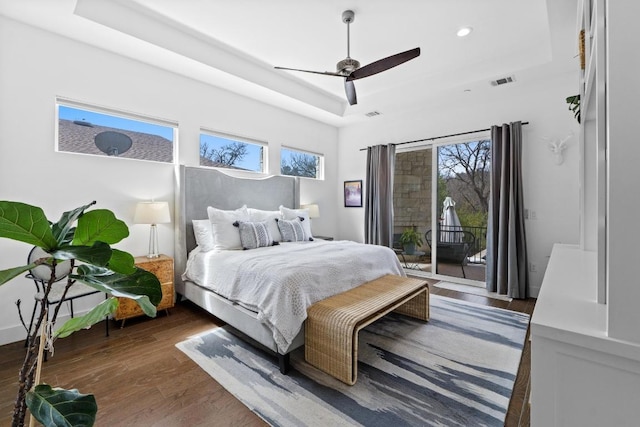 1006 Meriden Ln, Austin, TX 78703 - bedroom with a tray ceiling, access to outside, wood finished floors, multiple windows, and recessed lighting