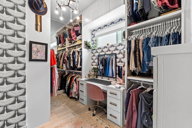 1006 Meriden Ln, Austin, TX 78703 - walk in closet featuring light wood-style floors and a chandelier