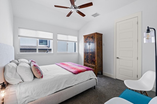 carpeted bedroom with lofted ceiling, baseboards, visible vents, and ceiling fan