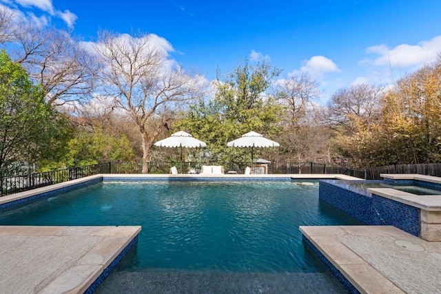 view of pool featuring a fenced in pool, an in ground hot tub, a fenced backyard, and a patio