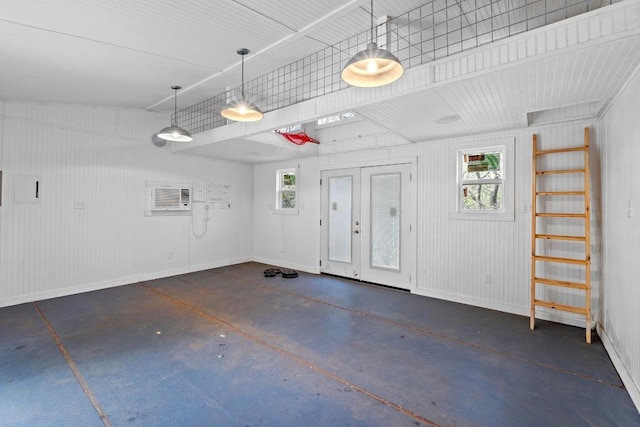 1006 Meriden Ln, Austin, TX 78703 - garage featuring french doors, baseboards, and a wall unit AC