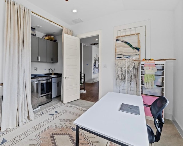 office with lofted ceiling, recessed lighting, baseboards, and a sink