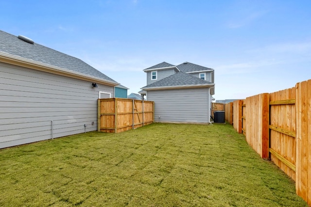 view of yard featuring a fenced backyard and central AC