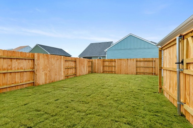 view of yard with a fenced backyard