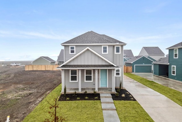 view of front of home with board and batten siding, an outdoor structure, roof with shingles, and fence