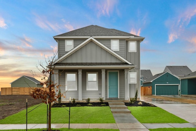 view of front facade with board and batten siding, a front yard, and fence