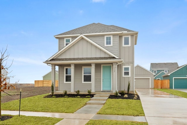 view of front of house featuring fence, board and batten siding, a front yard, and a shingled roof