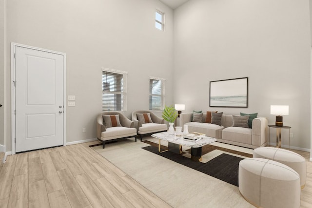 living room with a wealth of natural light, light wood-type flooring, and baseboards