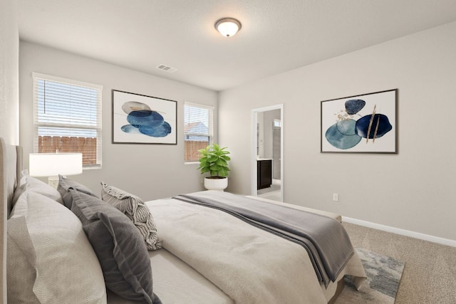 carpeted bedroom with visible vents and baseboards