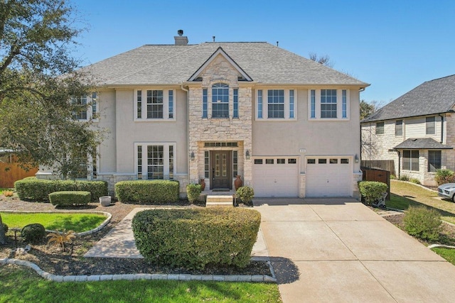 view of front of house featuring an attached garage, fence, a chimney, stone siding, and driveway