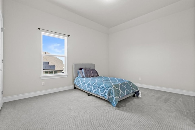 carpeted bedroom featuring baseboards