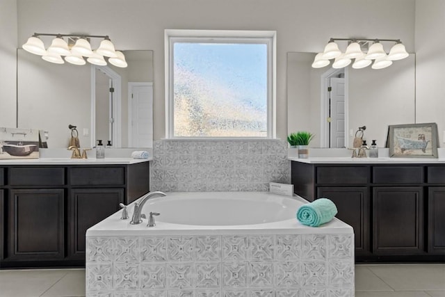 bathroom featuring tile patterned floors, a bath, two vanities, and a sink