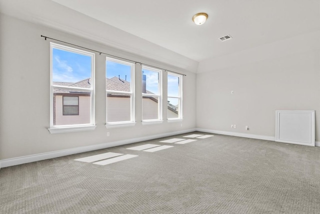 carpeted empty room featuring visible vents and baseboards