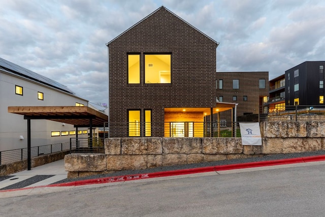 view of front of house with fence and brick siding