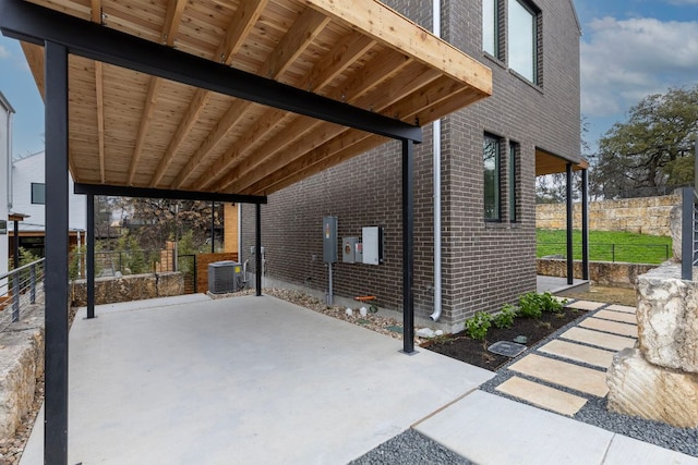 view of patio featuring cooling unit and fence